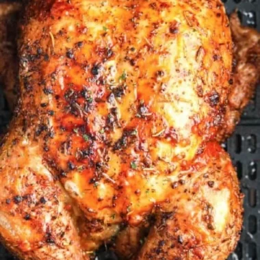 Crispy air fryer whole roasted chicken ready to serve on a platter.
