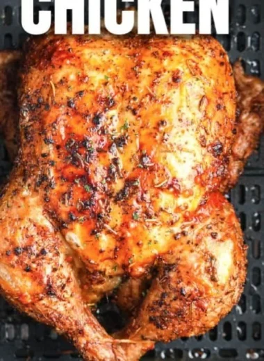 Crispy air fryer whole roasted chicken ready to serve on a platter.