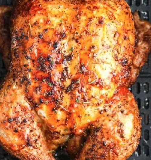 Crispy air fryer whole roasted chicken ready to serve on a platter.
