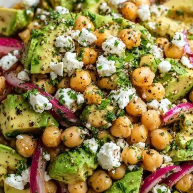 Chickpea Feta Avocado Salad garnished and served in a bowl with fresh ingredients.