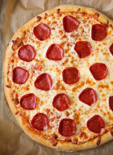 Delicious slice of pepperoni pizza with melted cheese and toppings