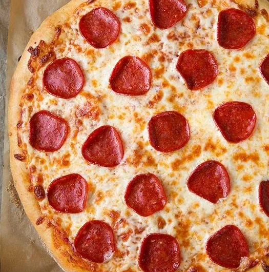 Delicious slice of pepperoni pizza with melted cheese and toppings