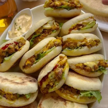 Freshly baked Plof Bread Rolls served on a wooden board