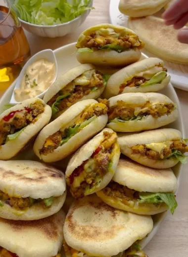 Freshly baked Plof Bread Rolls served on a wooden board
