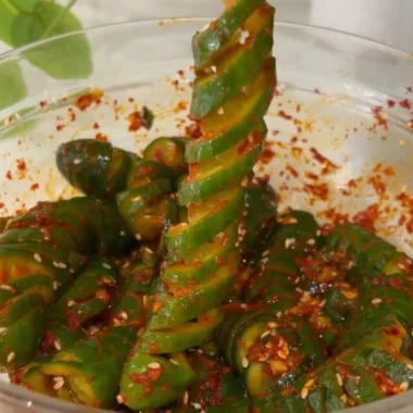Spiral cucumber salad with Korean-inspired flavors and colorful vegetables.