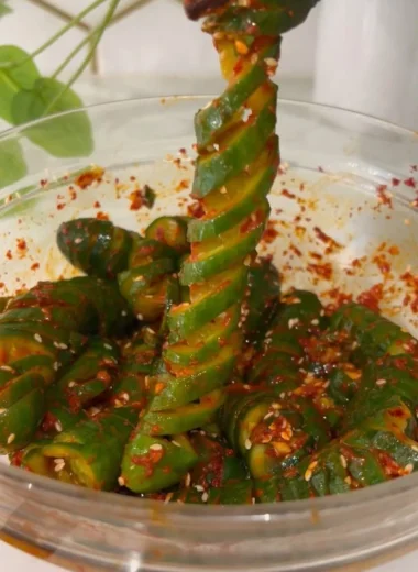 Spiral cucumber salad with Korean-inspired flavors and colorful vegetables.