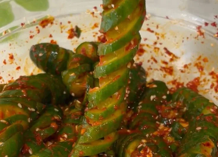 Spiral cucumber salad with Korean-inspired flavors and colorful vegetables.