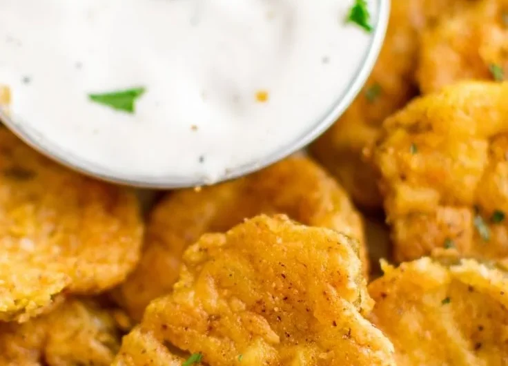 Deliciously crispy Air Fryer Fried Pickles served with a dipping sauce.