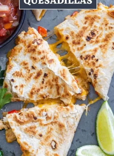 Delicious chicken quesadillas served on a plate with salsa and garnish.