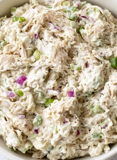 A bowl of fresh and colorful Chicken Salad with vegetables and dressing