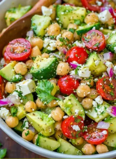Healthy chickpea salad with fresh vegetables and dressing