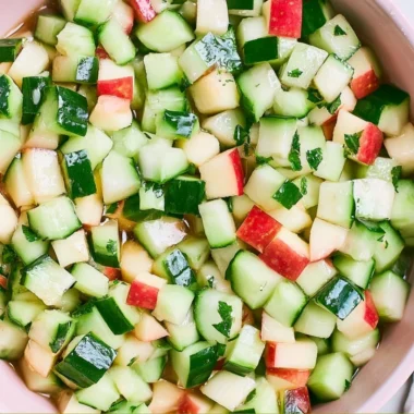 Fresh Cucumber Apple Salad with greens, apples, and dressing.