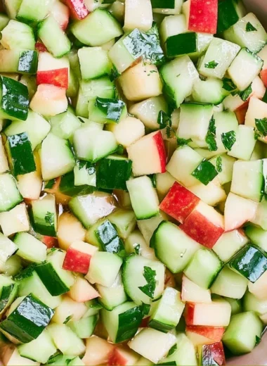 Fresh Cucumber Apple Salad with greens, apples, and dressing.