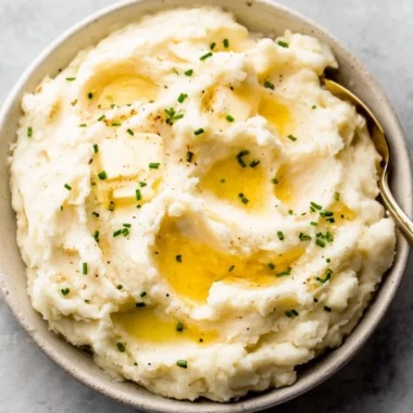 Bowl of easy garlic mashed potatoes topped with herbs