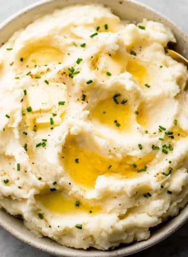 Bowl of easy garlic mashed potatoes topped with herbs