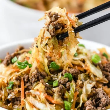 Delicious egg roll in a bowl, featuring fresh vegetables and savory meats.