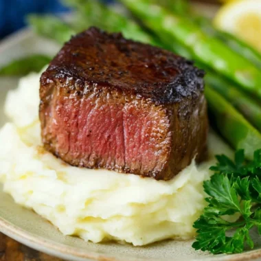 Delicious Filet Mignon topped with Garlic Herb Butter on a plate