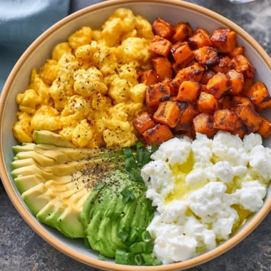 High-protein breakfast bowl filled with eggs, veggies, and quinoa