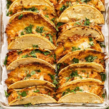 Mini Baked Chicken Tacos served on a plate with toppings.