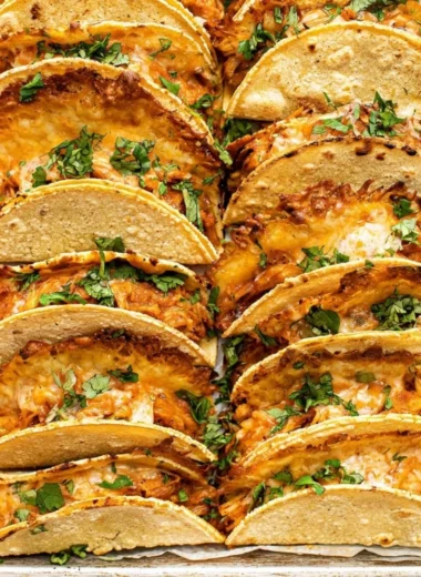 Mini Baked Chicken Tacos served on a plate with toppings.
