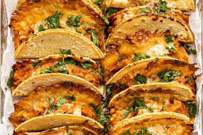 Mini Baked Chicken Tacos served on a plate with toppings.