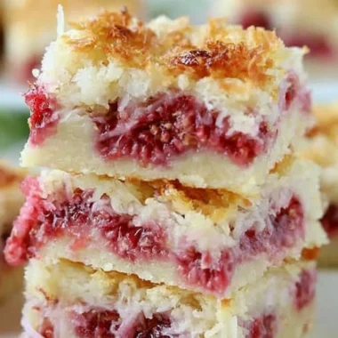 Delicious homemade Raspberry Coconut Bars on a plate.