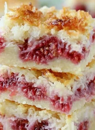 Delicious homemade Raspberry Coconut Bars on a plate.