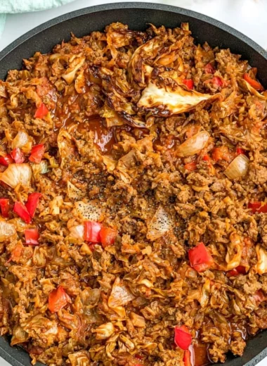 Delicious African cabbage stew with ground beef in a rustic bowl.