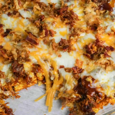 BBQ Bacon Cheeseburger Frito Pie topped with melted cheese and crispy bacon