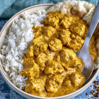 Delicious butter chicken in creamy tomato sauce served on a plate.