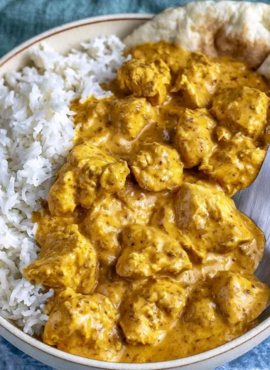 Delicious butter chicken in creamy tomato sauce served on a plate.