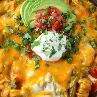 Easy and cheesy Chicken Fajitas Casserole topped with cheese and colorful peppers