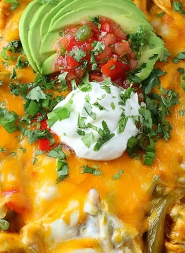 Easy and cheesy Chicken Fajitas Casserole topped with cheese and colorful peppers