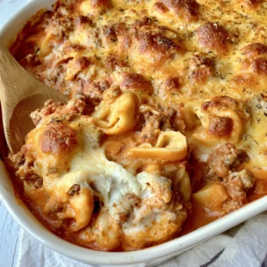 Cozy Cheesy Baked Tortellini Casserole topped with melted cheese and herbs