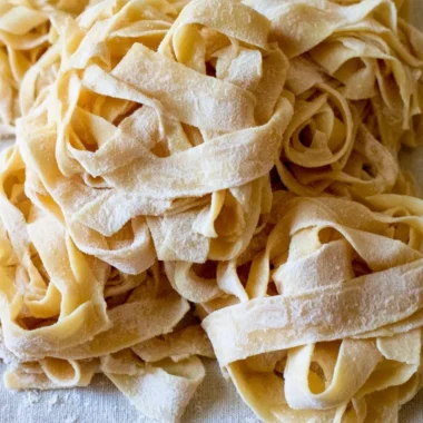 Cozy homemade sourdough pasta served with fresh herbs and sauce.