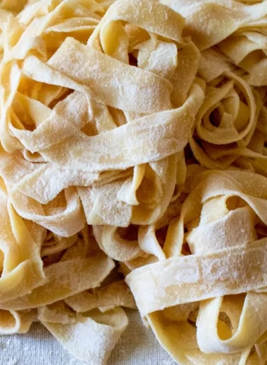 Cozy homemade sourdough pasta served with fresh herbs and sauce.
