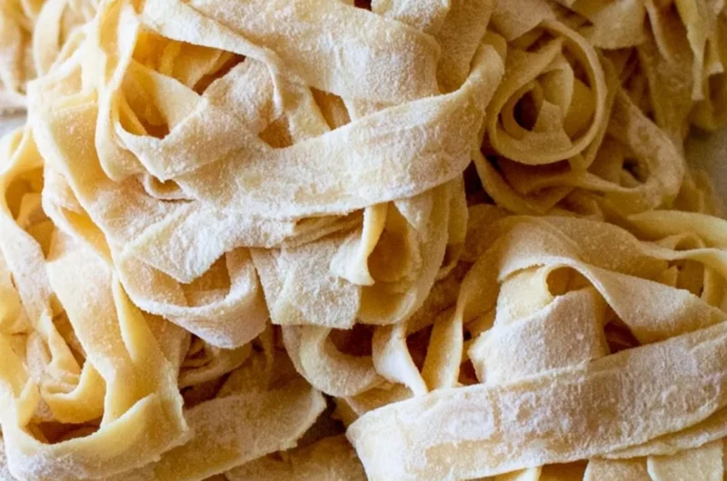 Cozy homemade sourdough pasta served with fresh herbs and sauce.