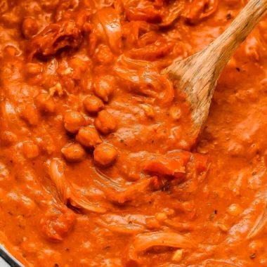Bowl of creamy coconut chickpea curry with fresh herbs and spices