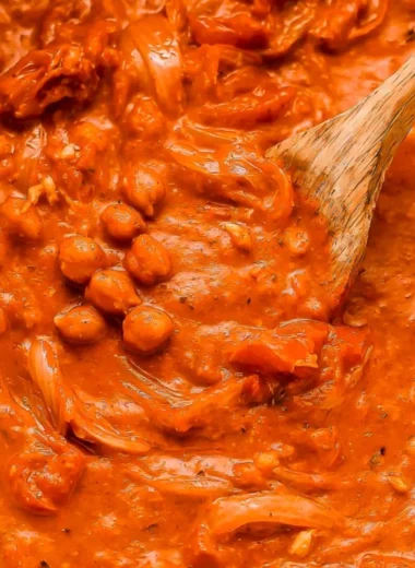 Bowl of creamy coconut chickpea curry with fresh herbs and spices