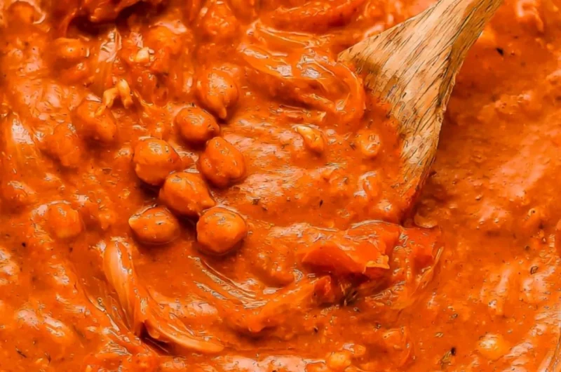 Bowl of creamy coconut chickpea curry with fresh herbs and spices