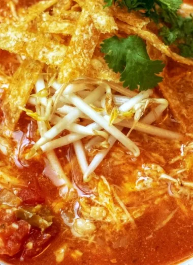 Crock Pot Chicken Tortilla Soup garnished with tortilla strips and cilantro