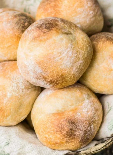 Golden brown crusty sourdough rolls fresh out of the oven