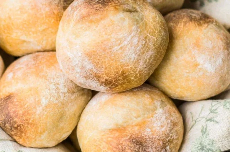 Golden brown crusty sourdough rolls fresh out of the oven
