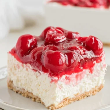 Delicious no bake cherry cheesecake topped with fresh cherries.