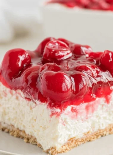 Delicious no bake cherry cheesecake topped with fresh cherries.