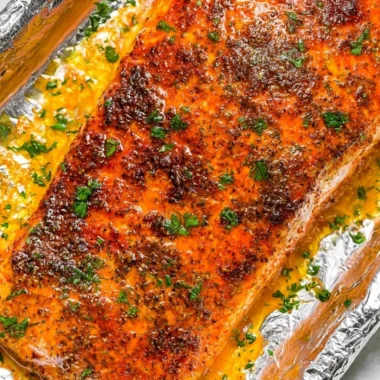 Delicious oven baked salmon fillets garnished with herbs and lemon