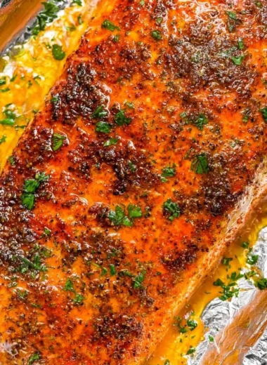 Delicious oven baked salmon fillets garnished with herbs and lemon