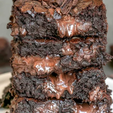 100 calorie fudge brownies in a baking dish, topped with chocolate drizzle.