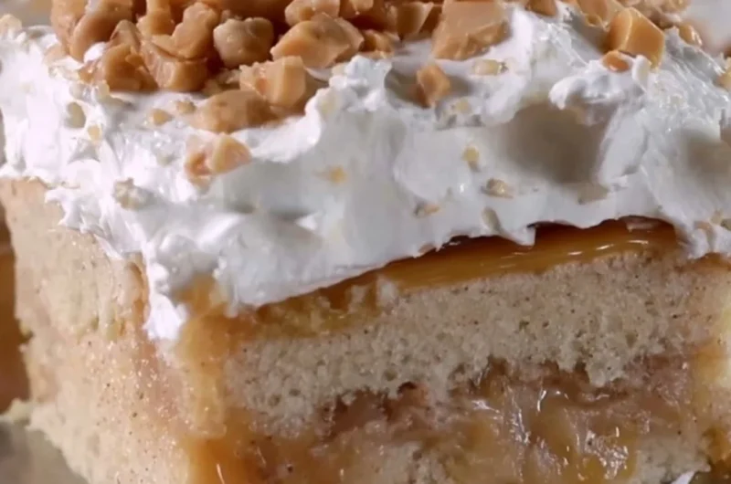 Delicious caramel apple poke cake topped with drizzled caramel and apples