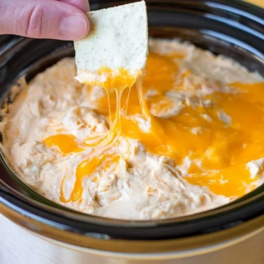 Creamy Maryland crab dip served in a bowl with crackers and garnished with herbs